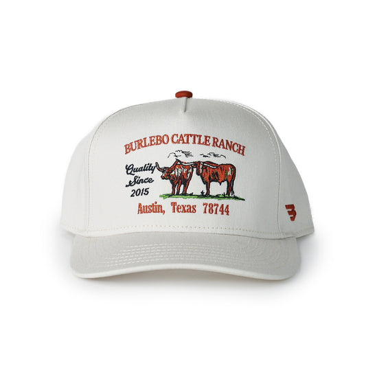White cap with red and black text and graphics on a white background
