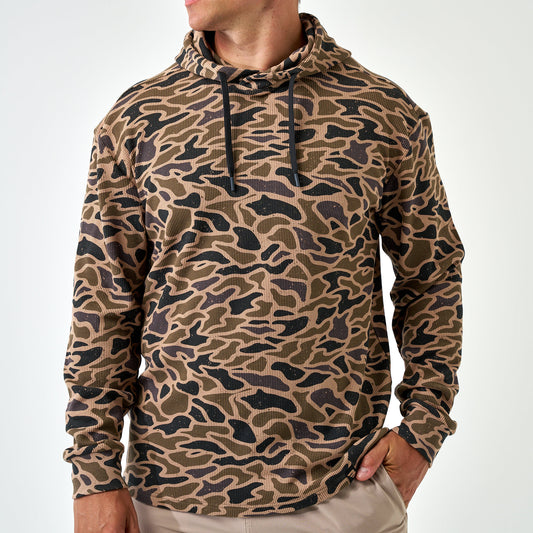 Man wearing the Gauge Camo Thermal Hoodie, front view with black drawstrings