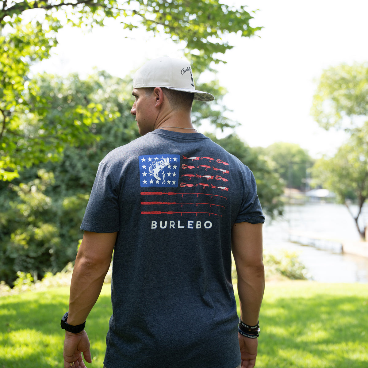Man wearing a navy blue t-shirt with a Burlebo logo outdoors
