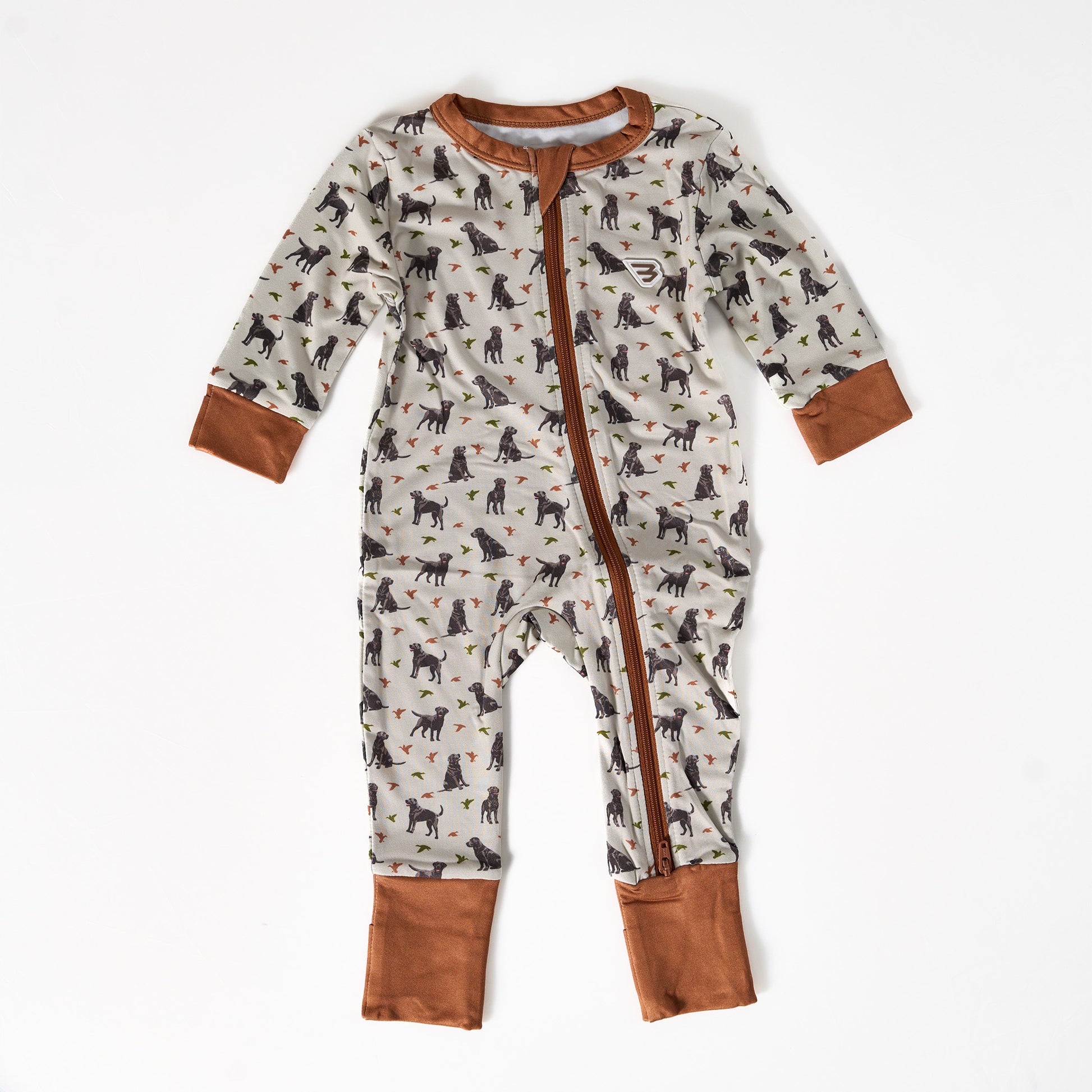 Baby onesie with dog pattern and brown accents on a white background