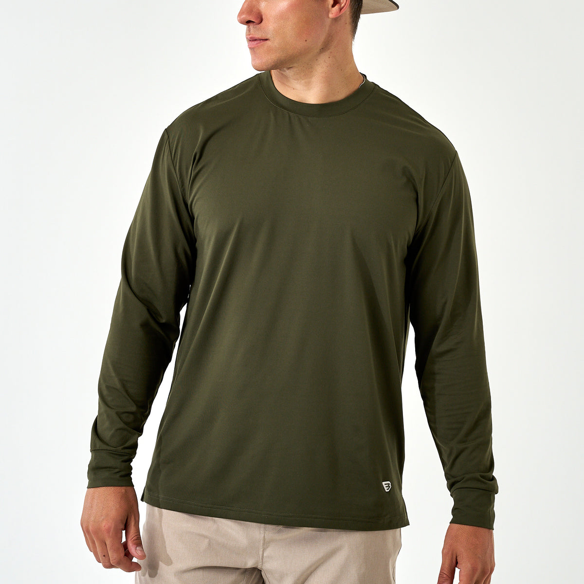 Man wearing the Mallard Green Long Sleeve Go To Tee with khaki pants, front view on a white background