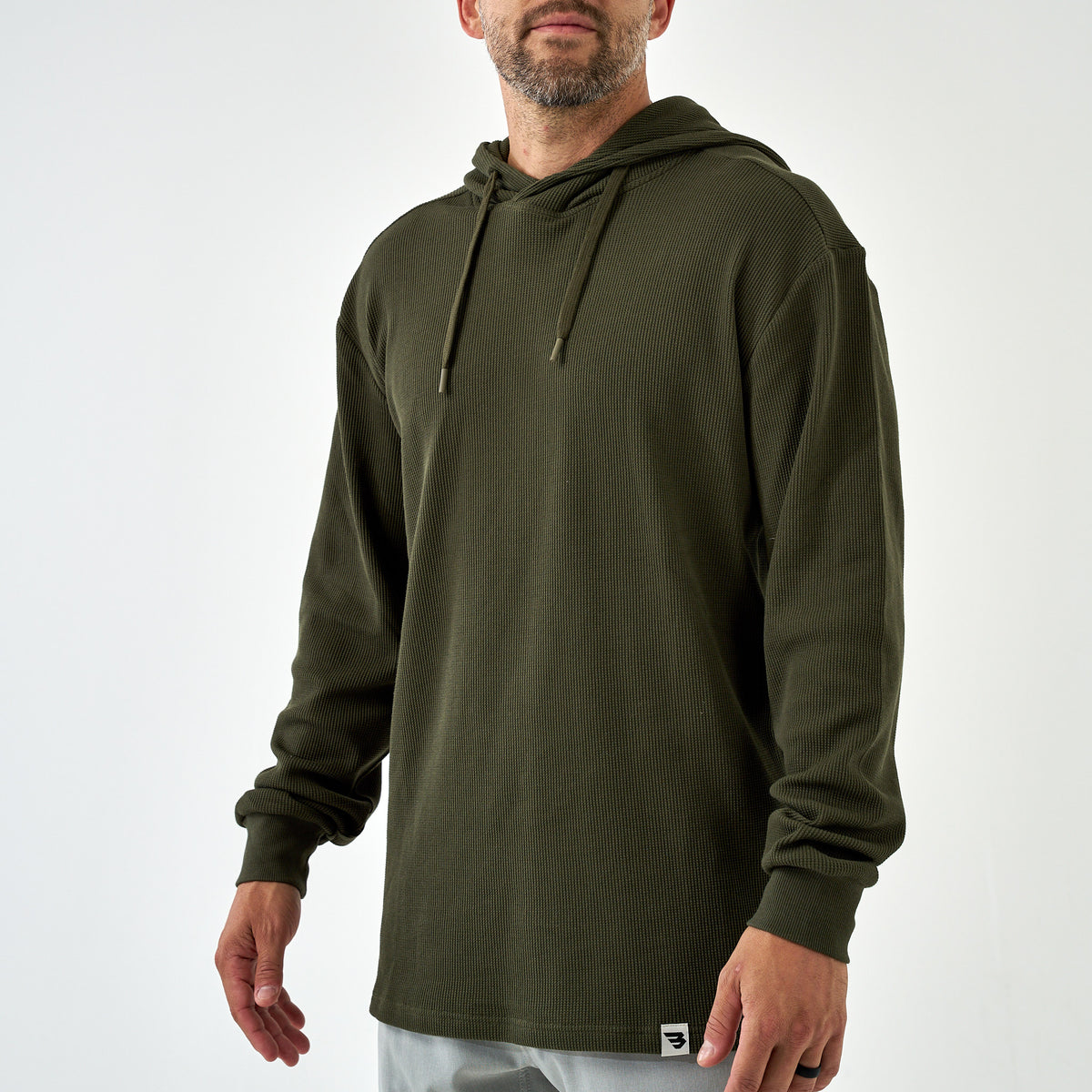 Man wearing the Mallard Green Thermal Hoodie, front view with drawstrings and hem logo tag