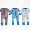 Three children's onesies with different patterns on a white background